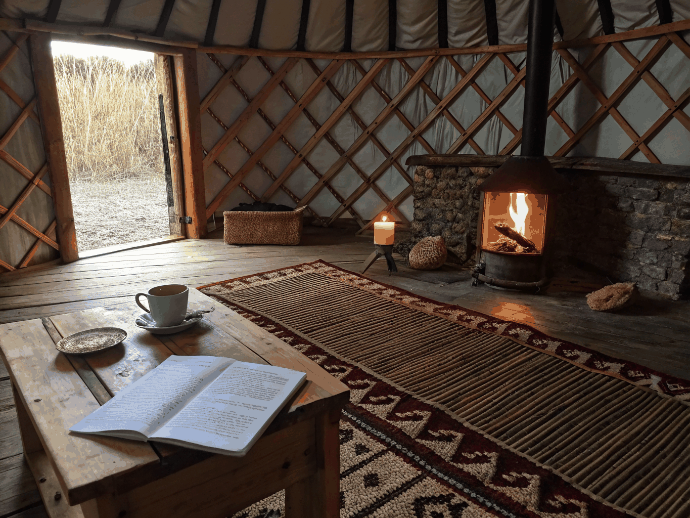 Luxurious yurt interior with made bed and rustic furniture